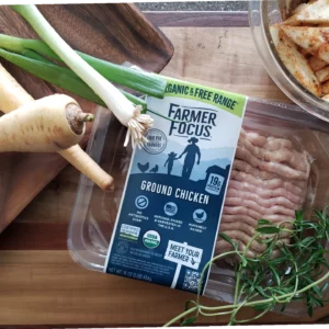 Farmer Focus Ground Chicken with vegetables on a counter.