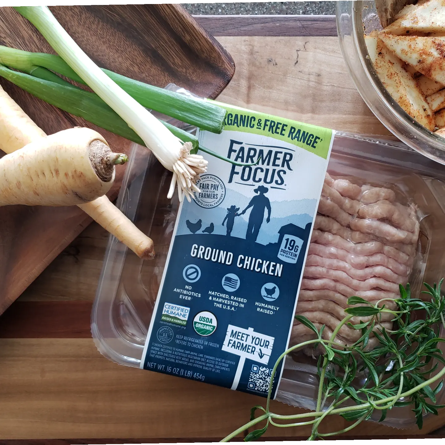 Farmer Focus Ground Chicken with vegetables on a counter.